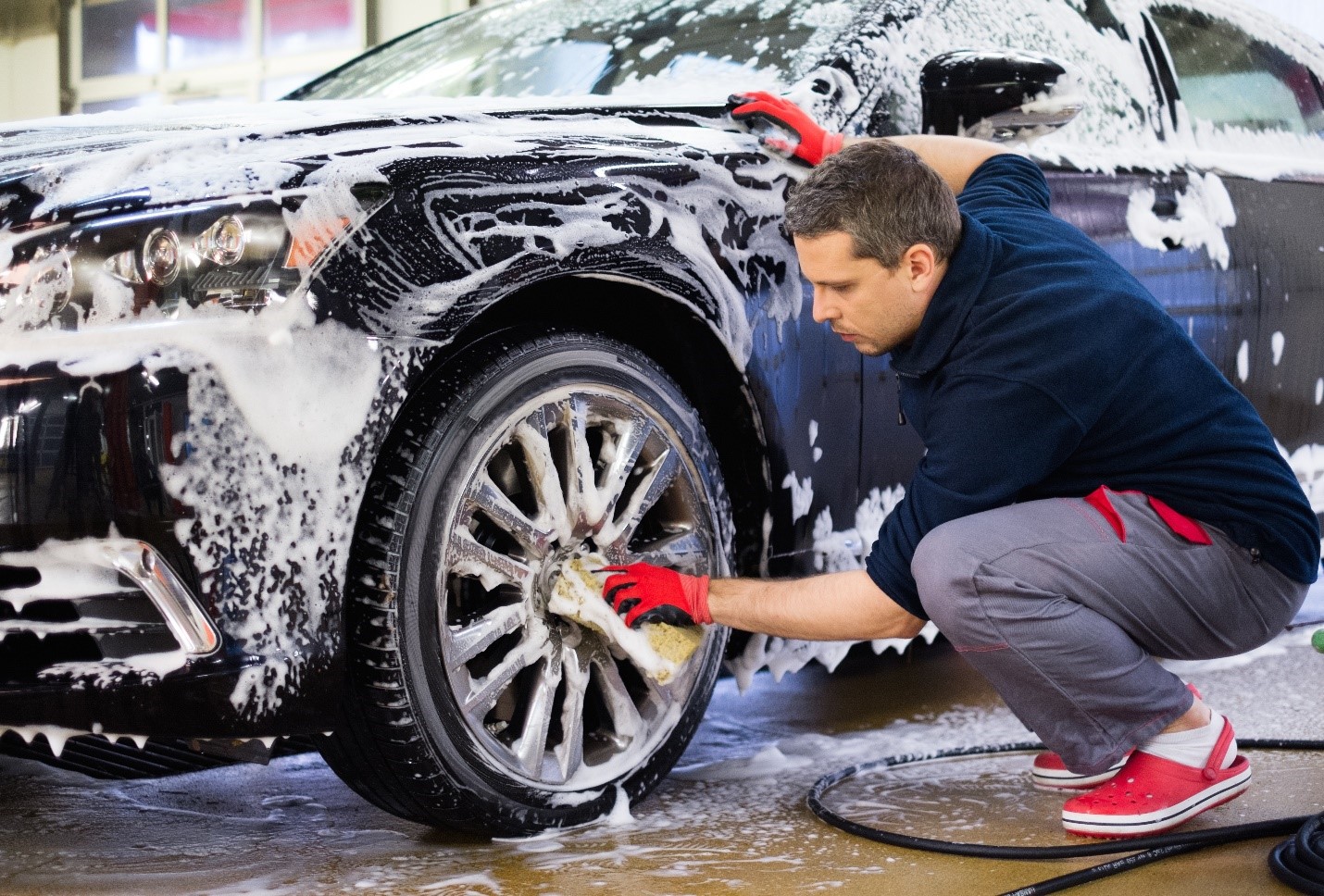 Guy Cleaning Car at a Car Wash